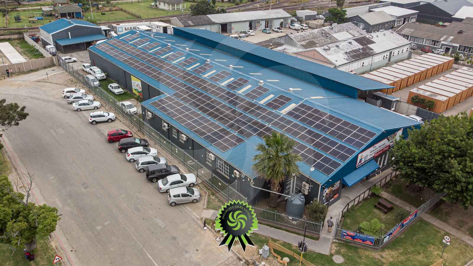 Arial of 85.8kWp Grid-tied and 19.8kWp for backup charging solar arrays at Grocery Express installation, George